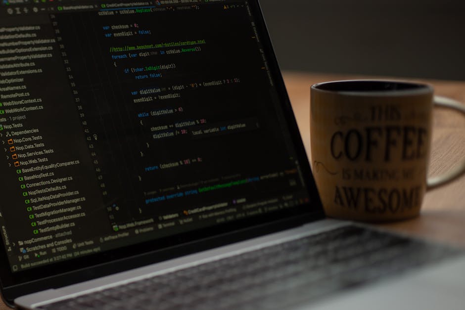A close-up photograph displays a computer screen with lines of code written in a text editor, showcasing HTML and CSS syntax in various colors including red, yellow, green, and white. The code include